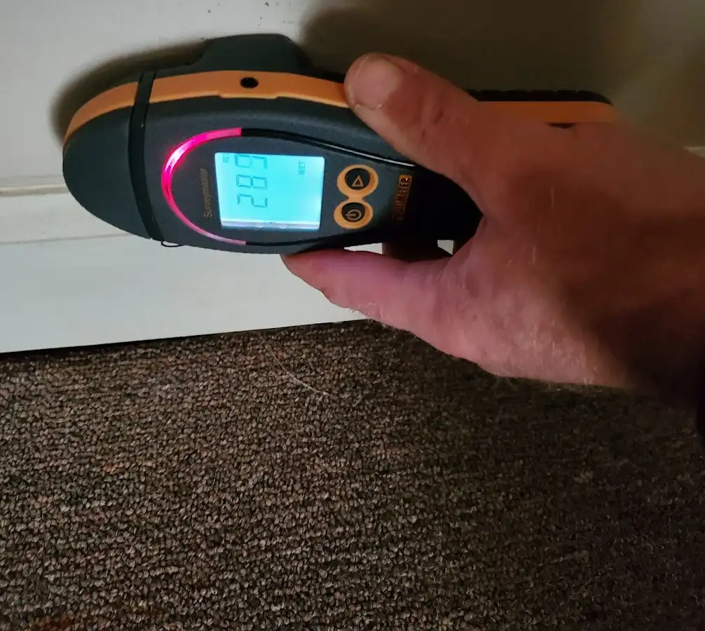 Moisture detection at baseboard during Storm Damage Restoration in Hooper